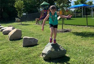 Employees enjoying a rock jumping activity during a Marian Inc. event